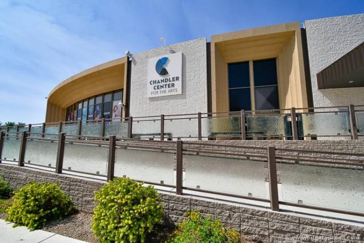 the exterior of the Chandler Center for the Arts -- a ramp leads up to a curved, light-colored building